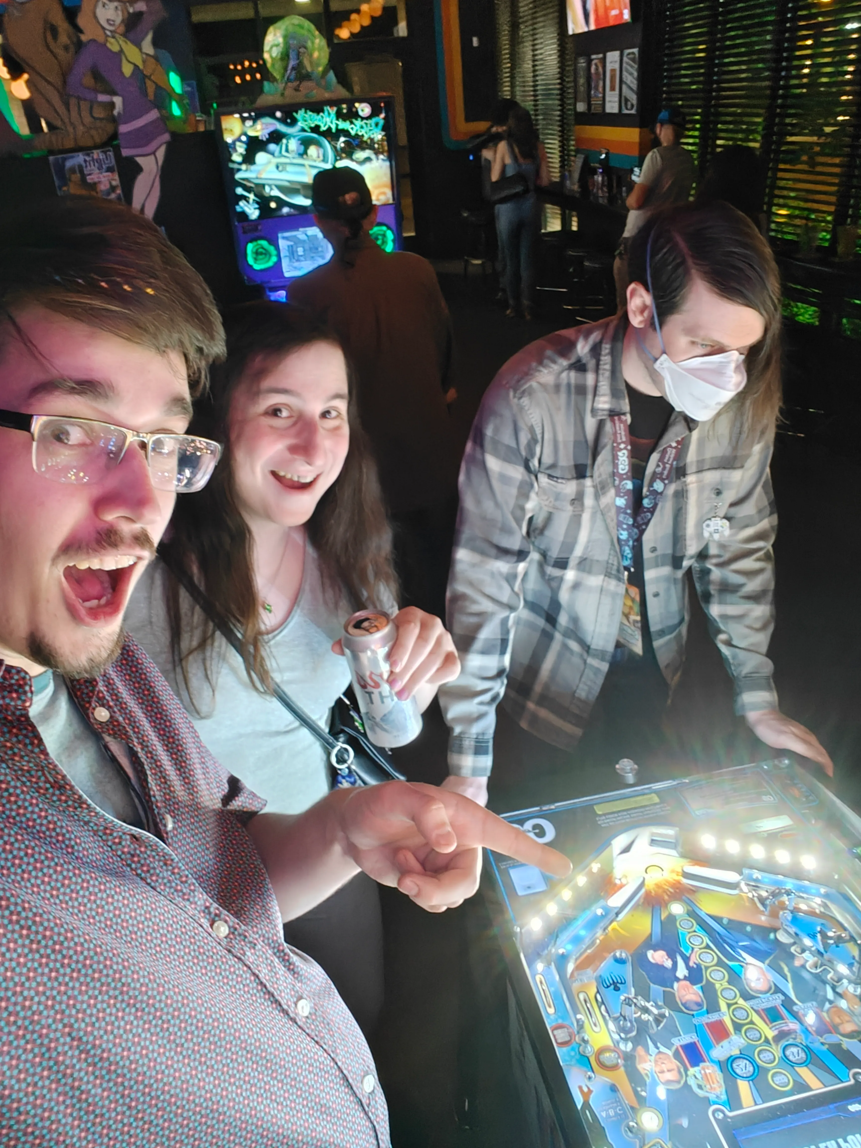 Myself, Flannelkat, and PeaceEgg standing around a James Bond pinball table